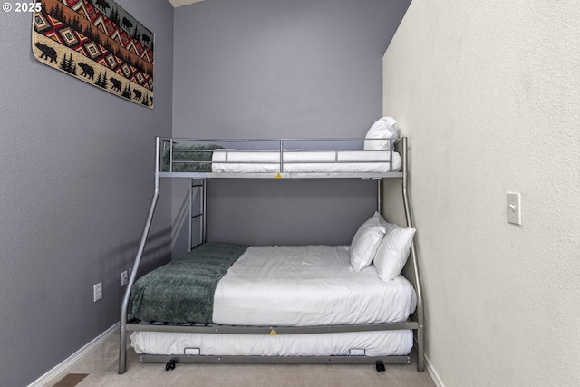 bedroom featuring baseboards and carpet