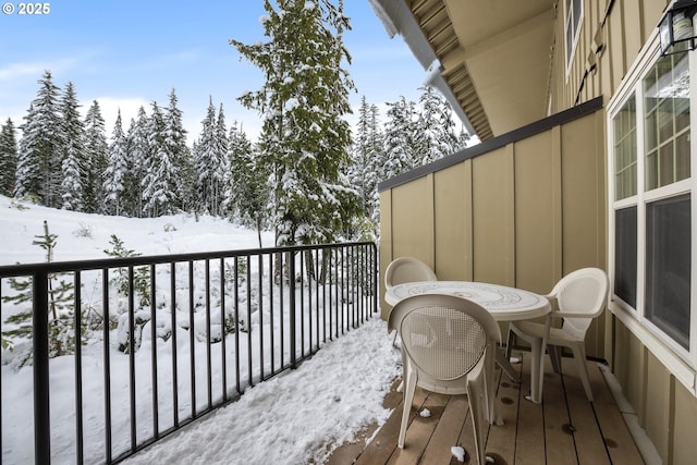 view of snow covered back of property