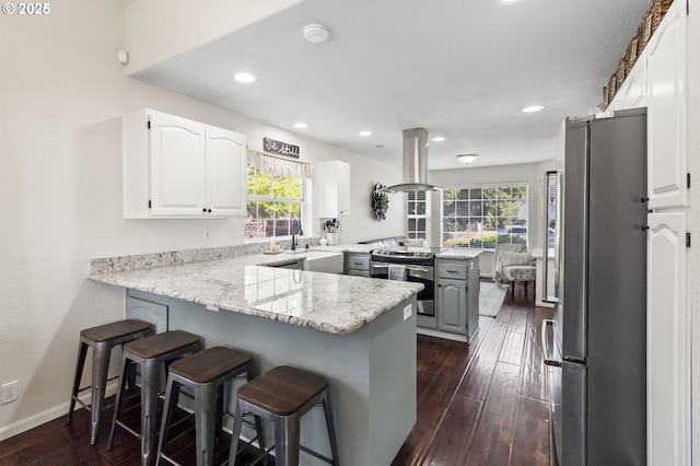 1537 W 13th Ave, Junction City, OR 97448 - kitchen with a peninsula, island range hood, appliances with stainless steel finishes, healthy amount of natural light, and recessed lighting