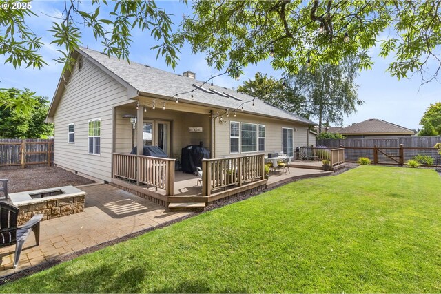 1537 W 13th Ave, Junction City, OR 97448 - rear view of property featuring a fire pit, a fenced backyard, a wooden deck, and a patio area