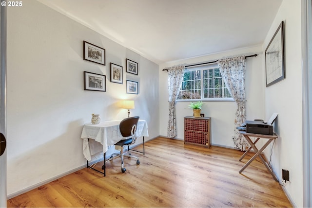 office area with baseboards and wood finished floors