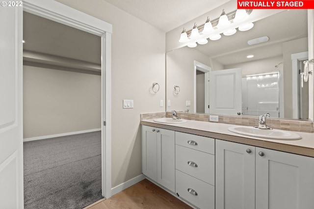 bathroom featuring vanity, wood-type flooring, and walk in shower