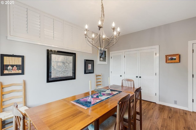 724 NW Westover Cir, Portland, OR 97210 - dining space with wood finished floors, a chandelier, and baseboards