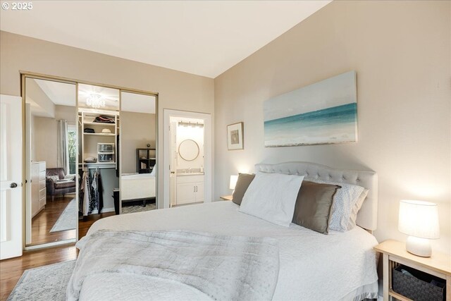 724 NW Westover Cir, Portland, OR 97210 - bedroom featuring wood finished floors, ensuite bath, and a closet