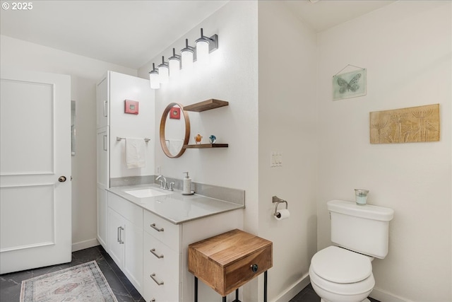 724 NW Westover Cir, Portland, OR 97210 - bathroom with baseboards, toilet, and vanity