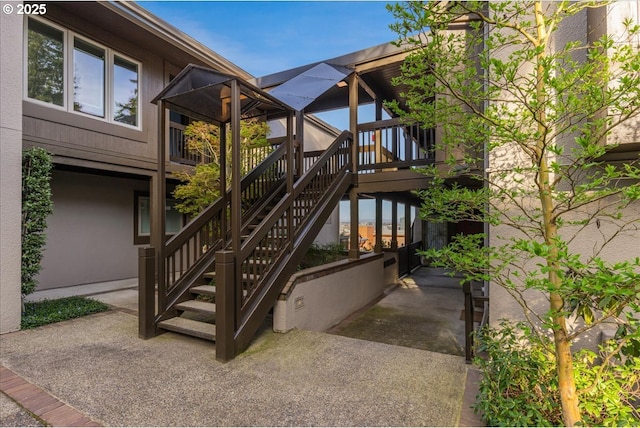 724 NW Westover Cir, Portland, OR 97210 - property entrance featuring stucco siding and a wooden deck