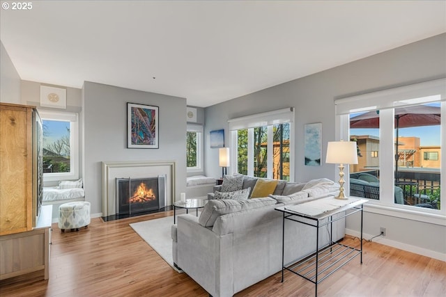 724 NW Westover Cir, Portland, OR 97210 - living room with a fireplace with flush hearth, wood finished floors, and baseboards