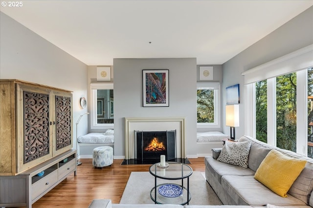 724 NW Westover Cir, Portland, OR 97210 - living area with wood finished floors, a fireplace with flush hearth, and baseboards