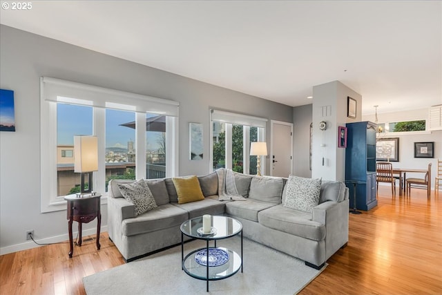 724 NW Westover Cir, Portland, OR 97210 - living room featuring light wood finished floors, plenty of natural light, and baseboards