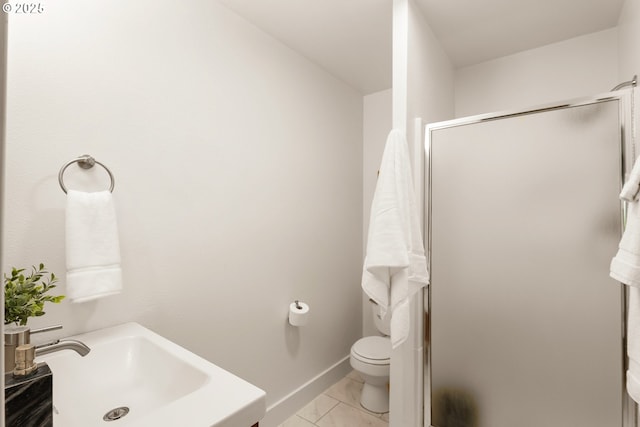 bathroom featuring baseboards, a stall shower, a sink, toilet, and marble finish floor