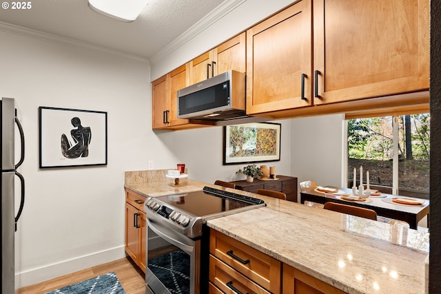 kitchen featuring light stone counters, baseboards, stainless steel appliances, crown molding, and light wood-type flooring