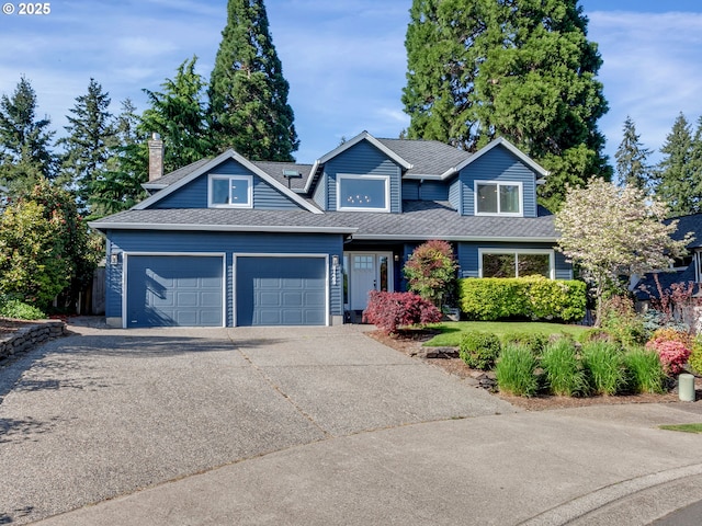 view of front of home with roof with shingles, driveway, and a garage