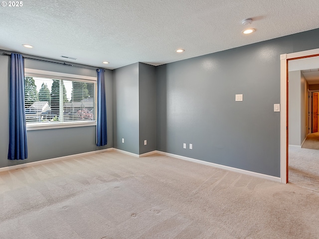 unfurnished room featuring a textured ceiling, carpet flooring, baseboards, and recessed lighting