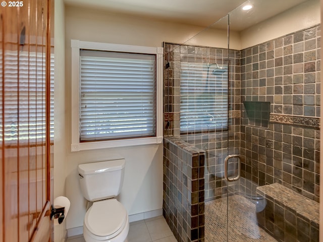 full bath featuring toilet, baseboards, tile patterned flooring, a shower stall, and recessed lighting