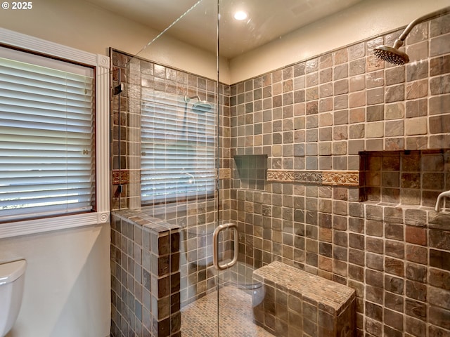 full bathroom with toilet and a shower stall
