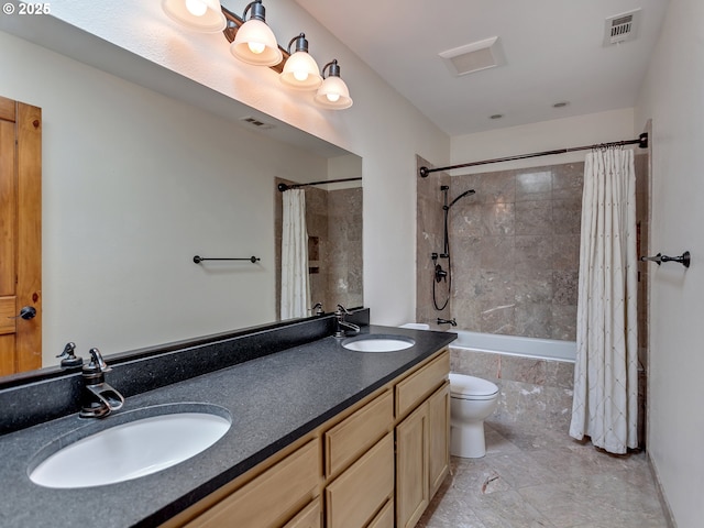 full bath featuring toilet, visible vents, tiled shower / bath combo, and a sink