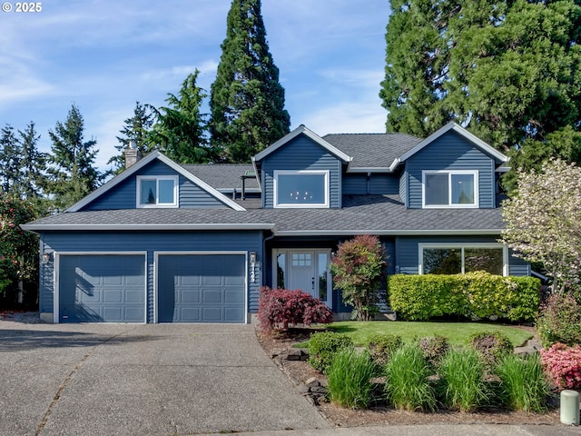 craftsman house featuring roof with shingles, a garage, a chimney, and driveway
