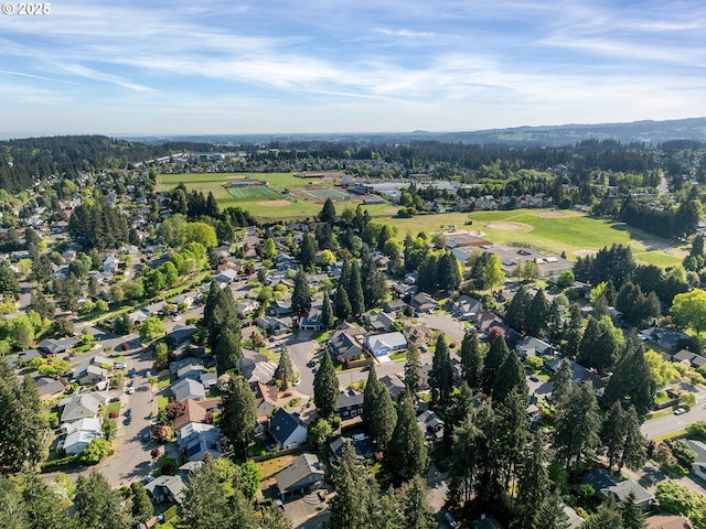 bird's eye view with a wooded view and a residential view
