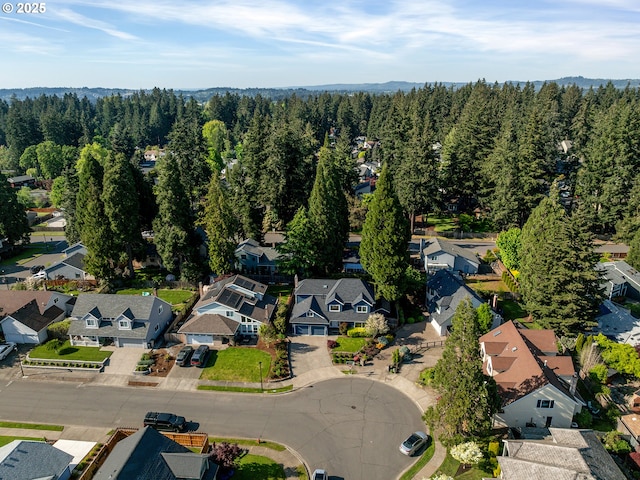 birds eye view of property featuring a forest view and a residential view