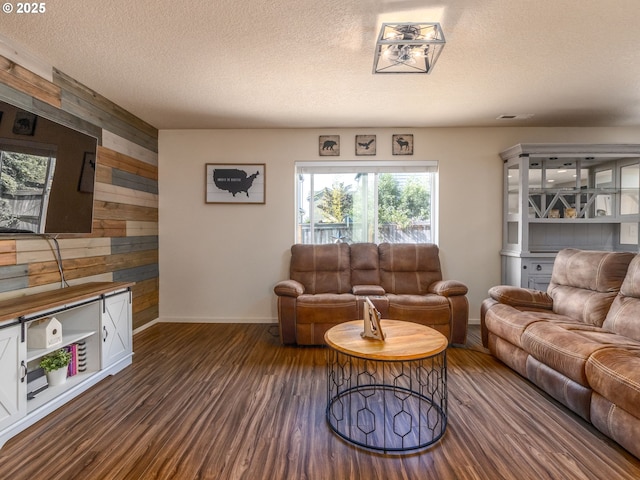 13012 NE 115th St, Vancouver, WA 98682 - living area featuring wooden walls, baseboards, dark wood-type flooring, and a textured ceiling
