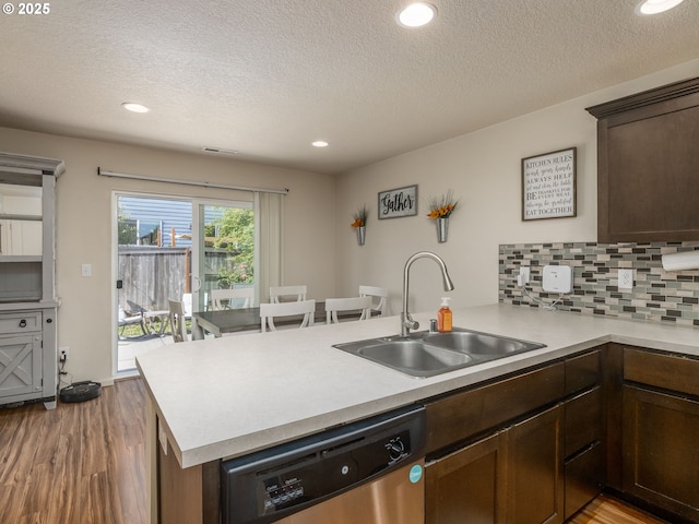 13012 NE 115th St, Vancouver, WA 98682 - kitchen featuring dishwasher, a peninsula, a sink, wood finished floors, and a textured ceiling