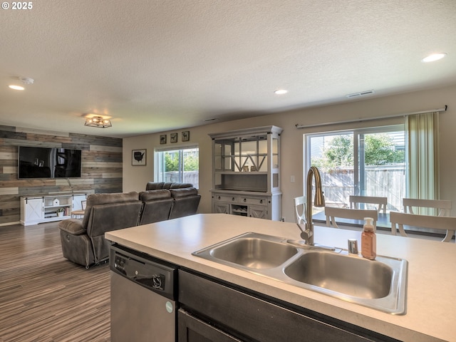 13012 NE 115th St, Vancouver, WA 98682 - kitchen featuring dishwasher, a sink, a textured ceiling, wood walls, and open floor plan