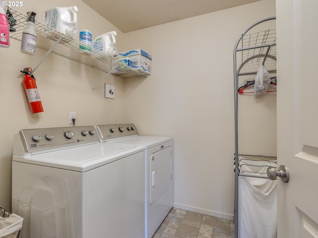 13012 NE 115th St, Vancouver, WA 98682 - washroom featuring washing machine and clothes dryer, light stone finish flooring, and baseboards