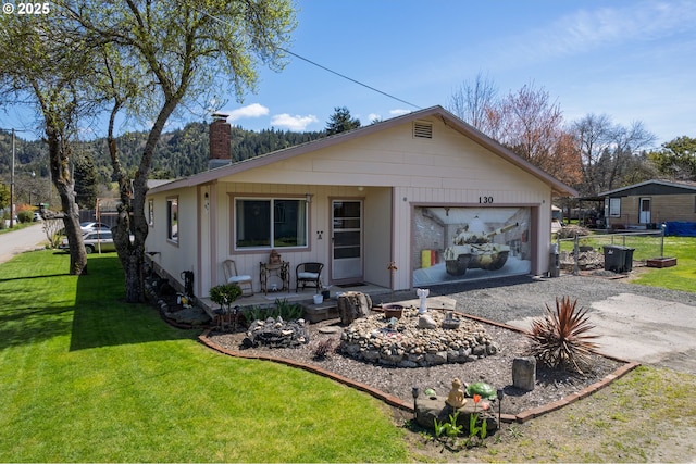 view of front of home with a garage and a front lawn