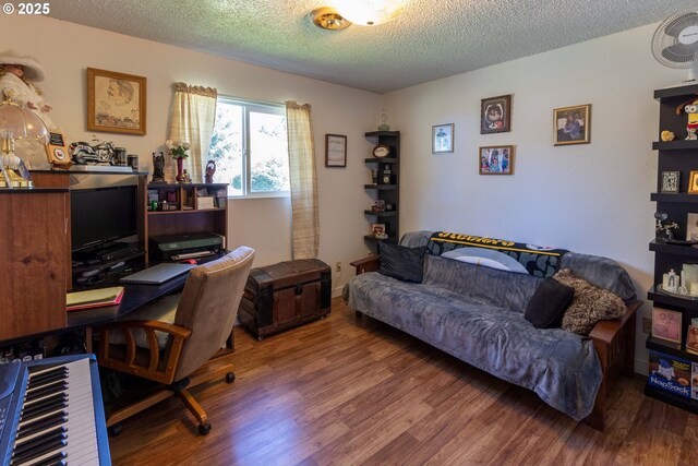 home office featuring hardwood / wood-style floors and a textured ceiling