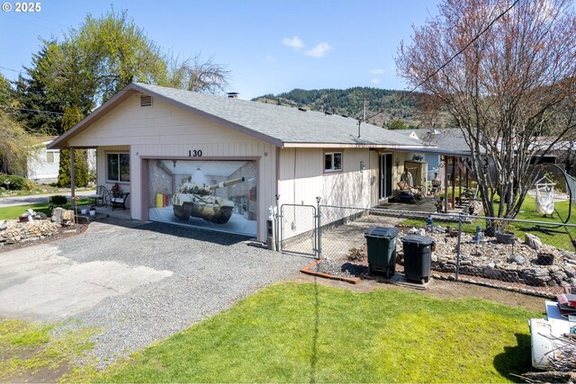 view of front of property featuring a garage and a front lawn