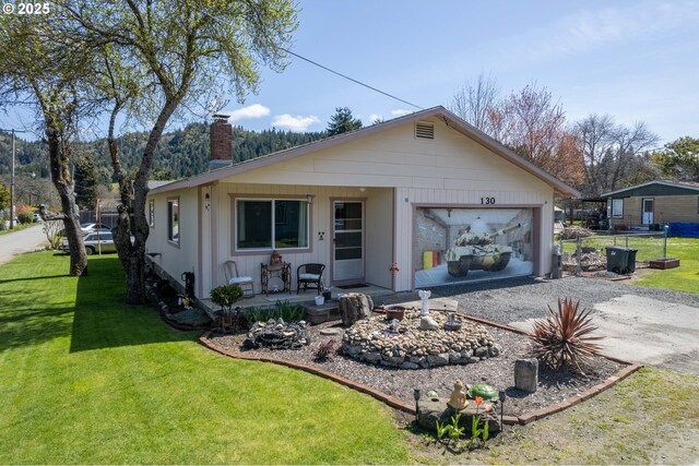 view of front facade with a garage and a front lawn