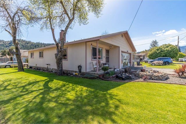 view of side of home with a yard and a garage