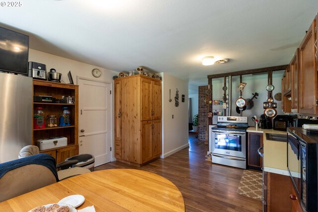 kitchen with dark hardwood / wood-style flooring, sink, and stainless steel range with electric cooktop