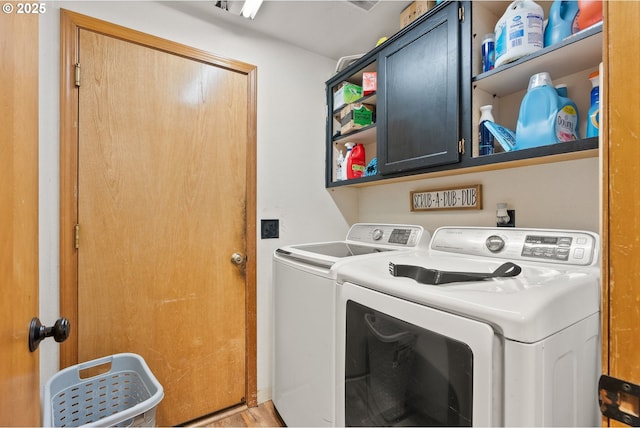 2012 SE Evans Ave, Troutdale, OR 97060 - washroom with cabinet space, independent washer and dryer, and light wood-type flooring