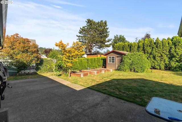 2012 SE Evans Ave, Troutdale, OR 97060 - view of yard featuring a vegetable garden, an outdoor structure, and a patio