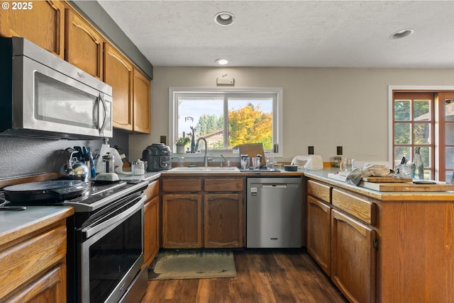 2012 SE Evans Ave, Troutdale, OR 97060 - kitchen with stainless steel appliances, a peninsula, dark wood finished floors, plenty of natural light, and recessed lighting