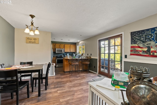 2012 SE Evans Ave, Troutdale, OR 97060 - dining room with dark wood-style flooring and a textured ceiling