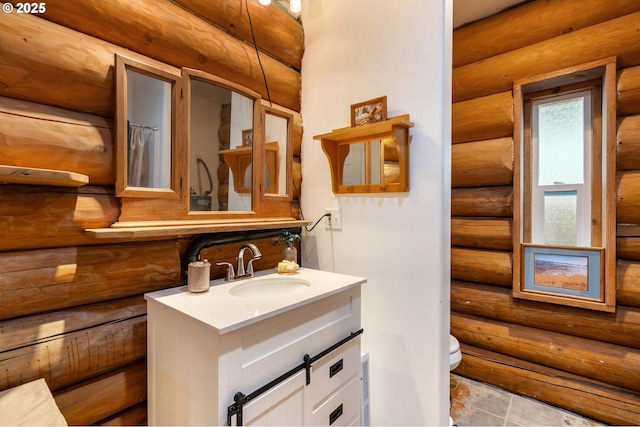 bathroom featuring log walls, tile patterned floors, vanity, and toilet