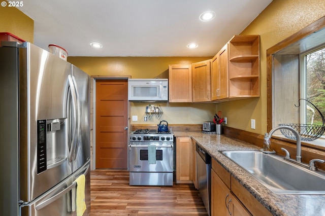 kitchen featuring open shelves, wood finished floors, recessed lighting, a sink, and appliances with stainless steel finishes