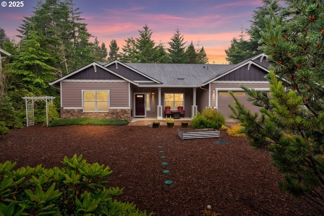 5030 Heceta Park Way, Florence, OR 97439 - view of front facade featuring a garage, stone siding, board and batten siding, and roof with shingles