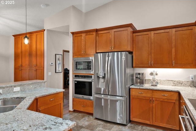 5030 Heceta Park Way, Florence, OR 97439 - kitchen with appliances with stainless steel finishes, brown cabinets, hanging light fixtures, and light stone counters