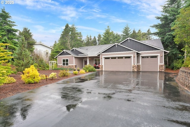 5030 Heceta Park Way, Florence, OR 97439 - view of front of house featuring an attached garage, stone siding, driveway, and board and batten siding