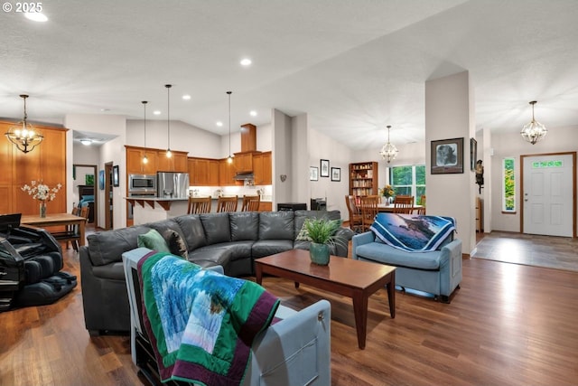 5030 Heceta Park Way, Florence, OR 97439 - living room with a chandelier, vaulted ceiling, and dark wood-type flooring
