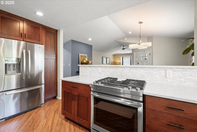 1613 SE Solomon Loop, Vancouver, WA 98683 - kitchen with appliances with stainless steel finishes, light countertops, backsplash, light wood-style flooring, and recessed lighting