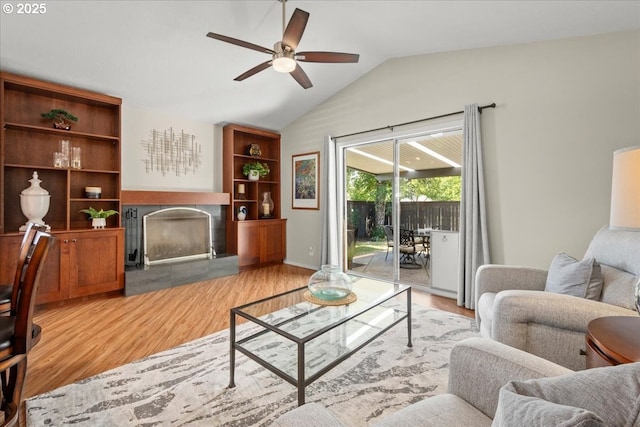 1613 SE Solomon Loop, Vancouver, WA 98683 - living room with a tile fireplace, a ceiling fan, wood finished floors, and lofted ceiling