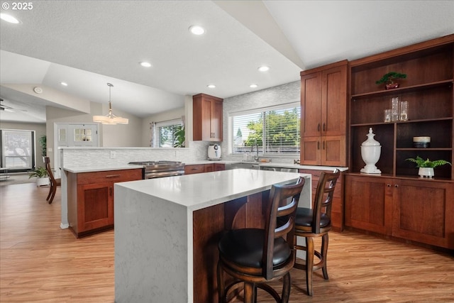 1613 SE Solomon Loop, Vancouver, WA 98683 - kitchen with vaulted ceiling, a peninsula, light wood-style flooring, recessed lighting, and light countertops
