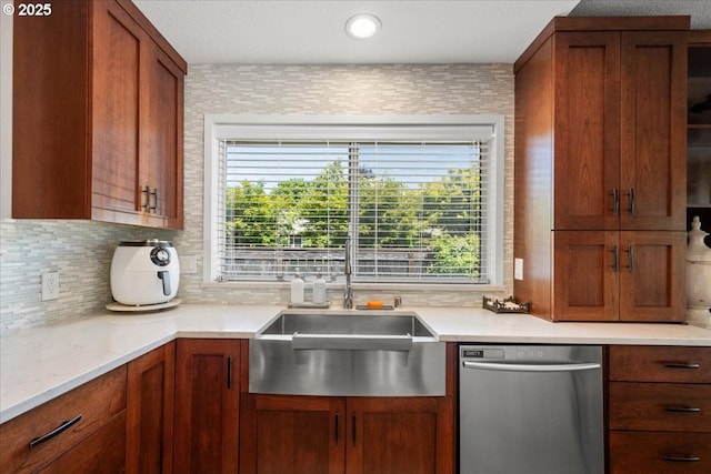 1613 SE Solomon Loop, Vancouver, WA 98683 - kitchen with dishwasher, light countertops, tasteful backsplash, and brown cabinetry
