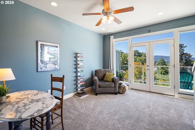 sitting room with carpet flooring, ceiling fan, and french doors