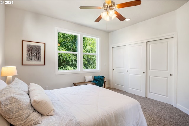 carpeted bedroom with a closet and ceiling fan