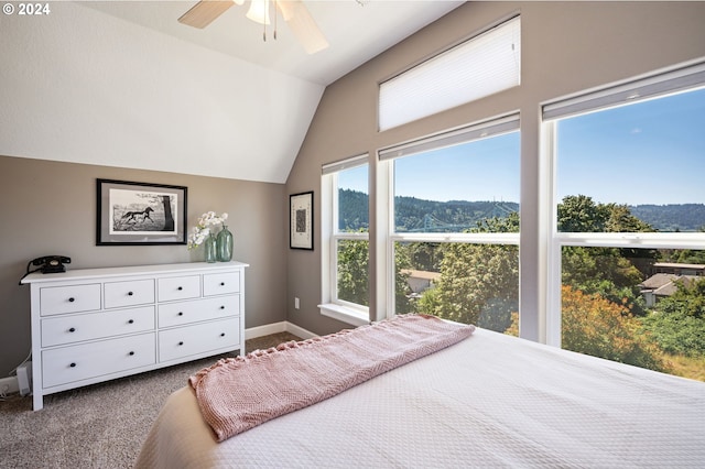 carpeted bedroom featuring ceiling fan and vaulted ceiling